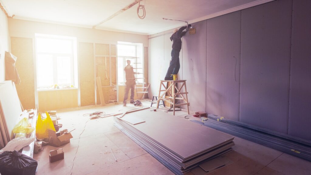 Workers installing drywall boards on interior walls during drywall boarding project in Abbotsford