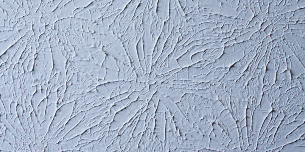 Modern curved drywall ceiling with recessed LED lighting in a commercial interior.
